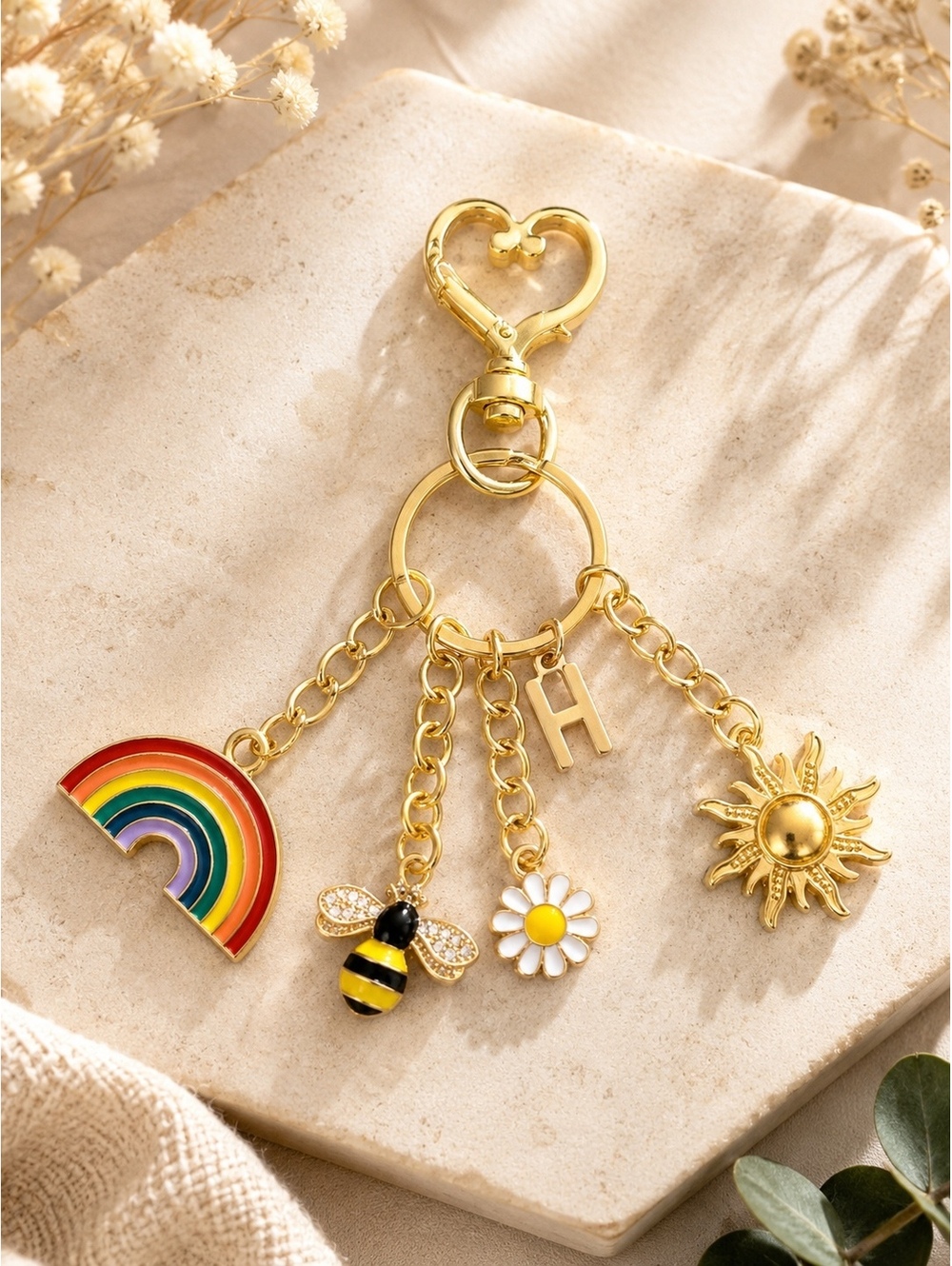 Gold Tone Customizable Charm Keychain with Rainbow, Bee, Daisy, Sun, and Initial